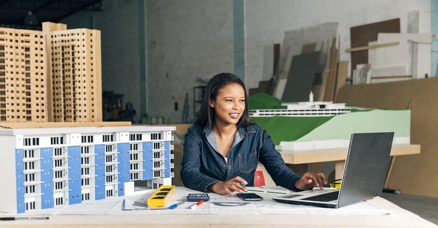 Architect's desk with a physical scale model of a building, the most common everyday use of 3D printing in architecture